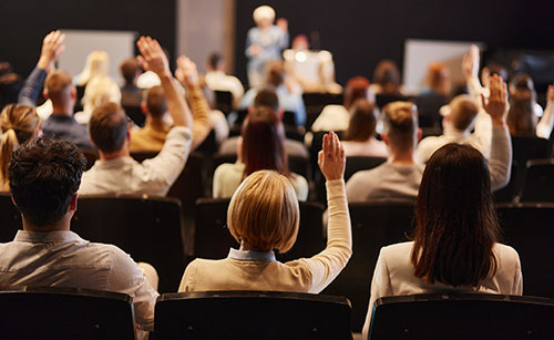 Audience raising hands