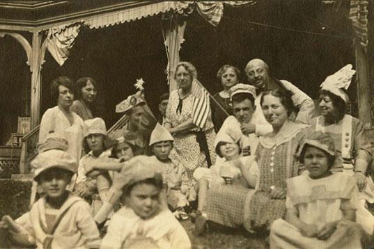 Black and white photo of women and children at a party in the U.S.