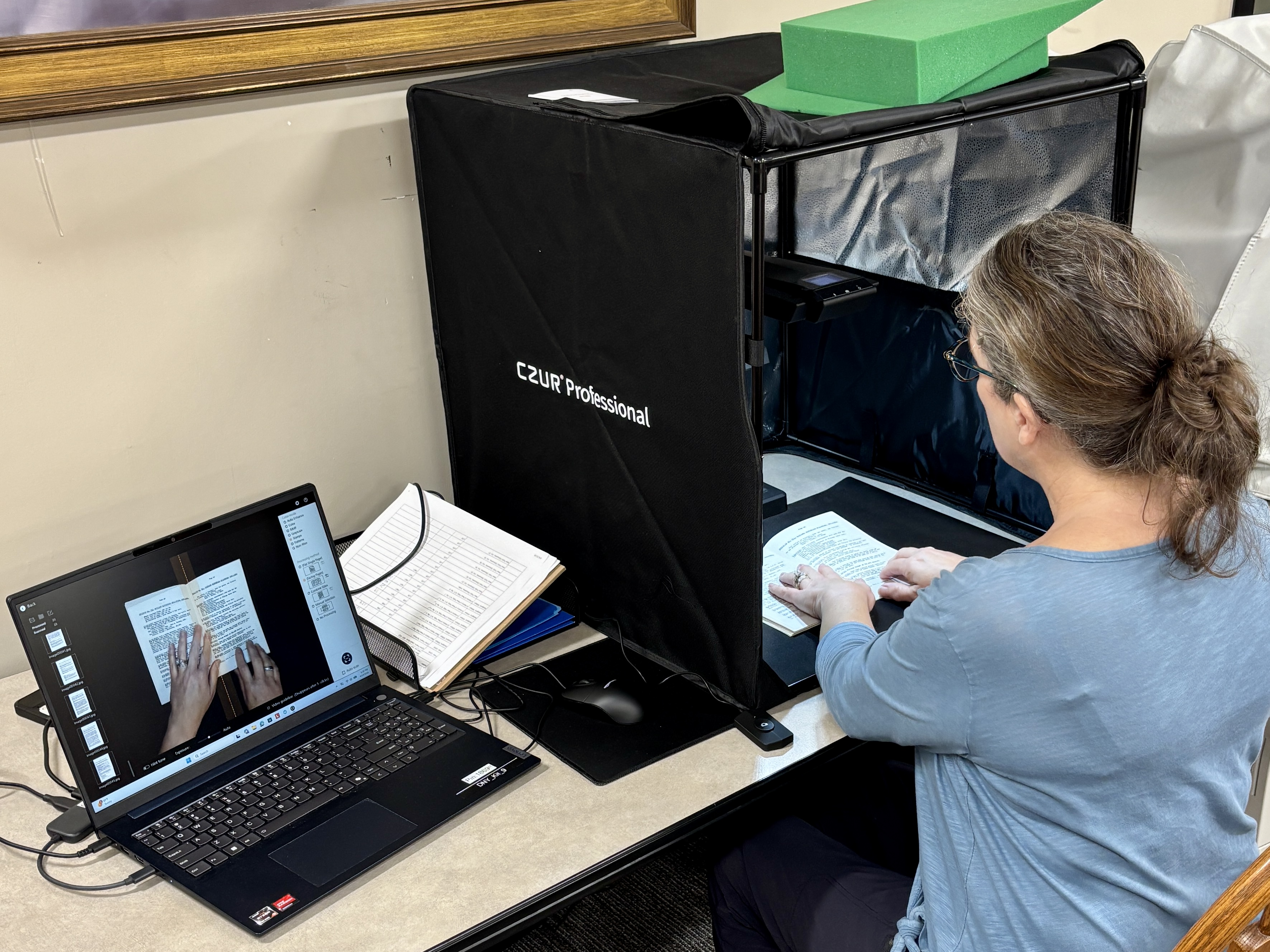 Volunteer using a CZUR scanner