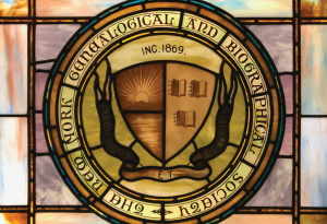 A stained glass window depicting the seal of the New York Genealogical and Biographical Society