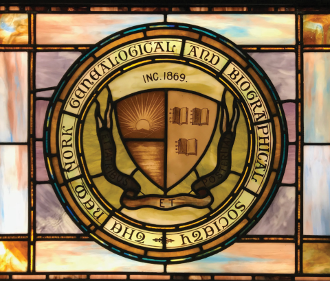 A stained glass window depicting the seal of the New York Genealogical and Biographical Society