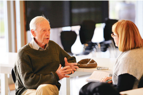 An older man being interviewed by a younger woman