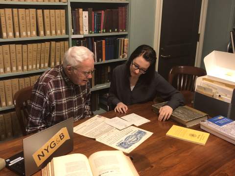 A professional genealogist consults with a client